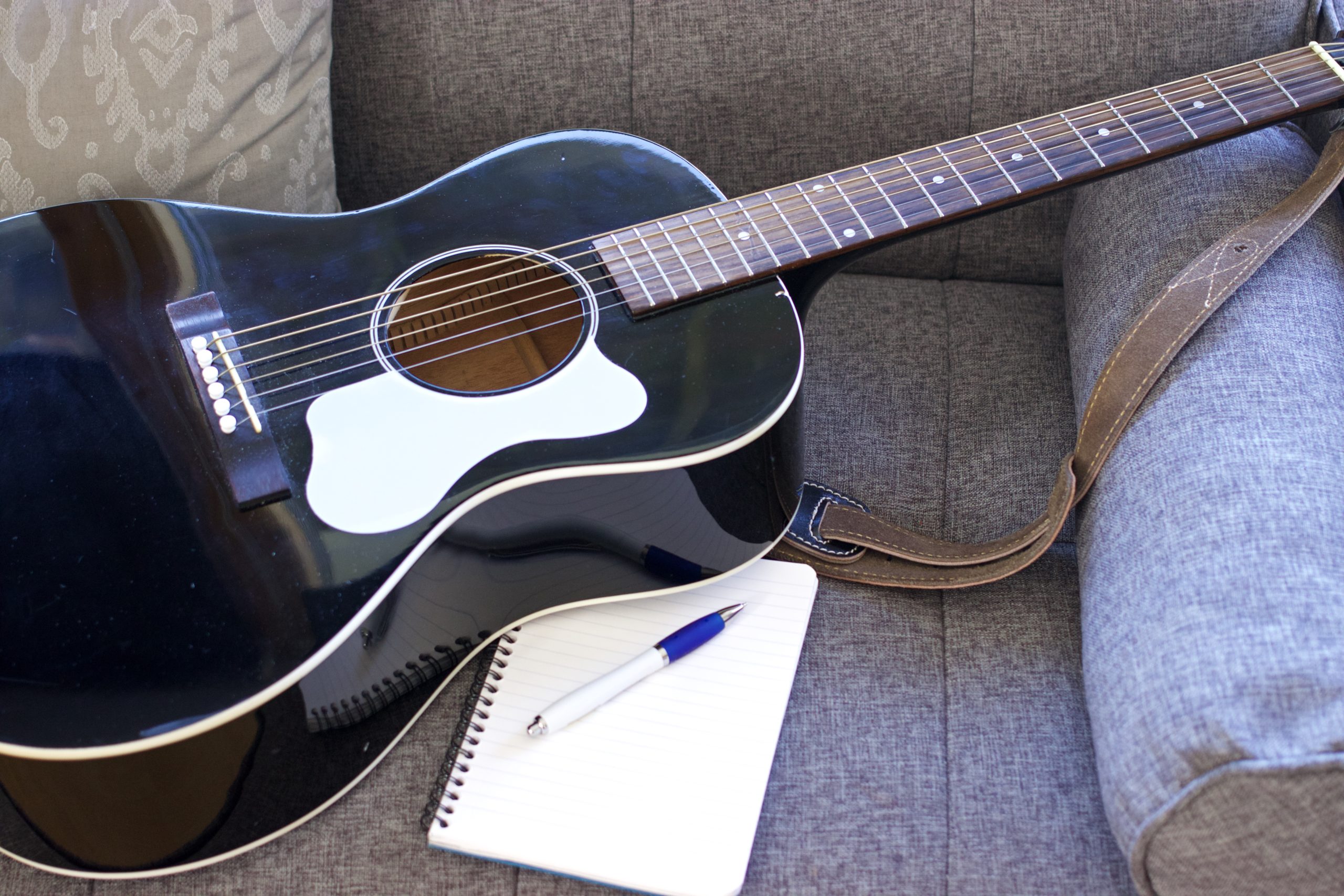 Guitar and notepad for songwriting